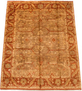 Perspective view of the gold wash Oushak design carpet with its floral rust border.