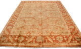 Angled perspective of a gold wash Oushak carpet with rust and terracotta floral details.