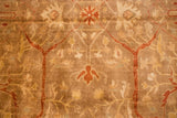 Detailed view of the hand-knotted pile showing copper and burnt orange floral vinery.