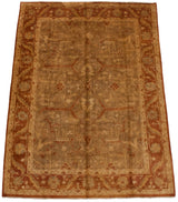 Angled view of a gold wash Oushak carpet with a lustrous floral field and rust-colored border.