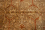 Terracotta vinery and floral designs on the lustrous gold-green pile of the Oushak carpet.