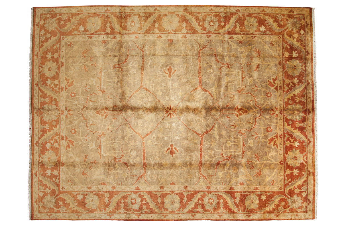 A gold wash Oushak design rug with an allover floral field and a wide, rust-colored palmette border.