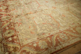 Corner detail of an Oushak rug featuring the soft pile and meandering rust vine border.