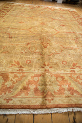 Low perspective highlighting the soft, lustrous pile of a gold and copper Oushak carpet.