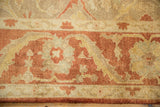 Meandering vine and palmette main border in tones of copper, rust, and dusty gold.