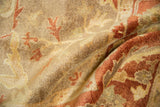 Soft, full pile of a hand-knotted Oushak carpet in gold, copper, and rust tones.