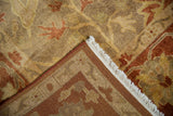 A folded corner of the Oushak carpet reveals its hand-knotted back, side selvage, and soft pile.
