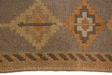 Distressed Soumac rug, hand-woven geometric pattern in beige, sand, and pale burnt orange.