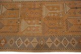 Geometric diamond border and stylized patterns in beige, sand, and burnt orange Soumac weave.