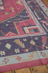 Detailed view of a vintage Dhurrie's flatweave in raspberry, deep navy, and powder blue.