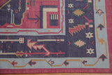 Corner of a vintage dhurrie with intact selvage and geometric patterns in raspberry and navy.