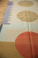 Madder root rust red circle with beige and pale blue blocks on the contemporary kilim.