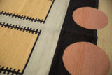 Contemporary Kilim rug featuring tan and beige geometric motifs with pale cinnabar circles.