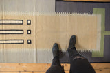 Contemporary kilim runner with stepped beige, grey, and black geometric block pattern.