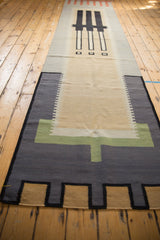 Abstract modern geometric stepped pattern in charcoal, beige, and dusty green kilim.