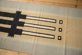 Abstract contemporary kilim runner with stepped geometric pattern and black outlined shapes.