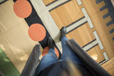 Abstract geometric patterns and large orange circles on a vintage contemporary Kilim rug.