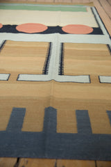 Abstract contemporary kilim showing charcoal geometric forms, sand ground, golden abrashes, and track trails.