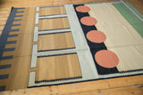 Bottom edge of vintage contemporary Kilim featuring black segmented border and pale madder red circle.