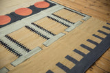 Contemporary Kilim rug geometric detail showing sand, slate, black track trails, and cinnabar circles.