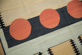 Playful cinnabar red circles, dark navy stripe, and geometric accents on vintage kilim.