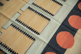 Abstract contemporary kilim rug showing bold cinnabar red circles on charcoal black and ivory.