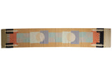 Contemporary Kilim runner featuring abstract geometric pinwheel design in sand, blue, and red.