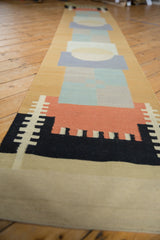 Flat-woven Kilim runner with abstract black, madder red, and beige geometric pattern.