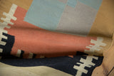 Flatweave contemporary Kilim runner with abstract geometric pattern in sand, black, and red.