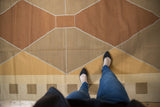 Hand woven contemporary kilim displaying copper, beige, and gold argyle diamond pattern.