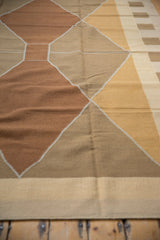 Geometric striped pattern on the vintage kilim, featuring beige, dusty ivory, and gold tones.
