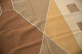 Handwoven vintage kilim detail showing modern Argyle-inspired copper and beige diamond pattern.