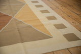 Modern kilim rug corner with intersecting argyle diamonds and rectangular block border.