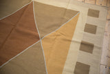 Modern kilim rug corner featuring coffee brown and dusty ivory rectangular blocks.