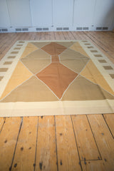 Contemporary hand woven Kilim carpet with modern argyle diamond pattern in copper, beige, ivory, gold, brown.