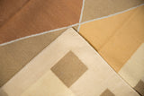 Hand woven contemporary kilim corner revealing flat weave texture, copper, ivory, and beige blocks.