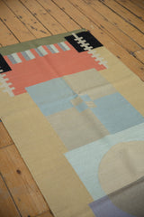 Layered abstract geometric design with sand, powder blue, and coral on the vintage Kilim.