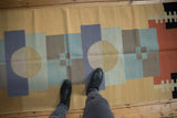 Layered abstract geometric pinwheel design on a vintage contemporary Kilim runner.