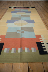 Layered abstract geometric pattern on vintage contemporary Kilim rug, featuring sand, blue, and red.