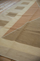 Detail of modern hand woven Kilim rug's argyle-inspired pattern in copper and beige tones.