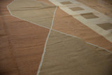 Hand-woven modern Kilim texture with geometric copper, bronze, and ivory diamond pattern.