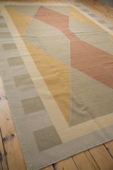 Vintage kilim rug with modern geometric design featuring beige, gold, and copper shapes.