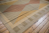Kilim rug edge displaying modern argyle pattern in beige, copper, and dusty gold flatweave.