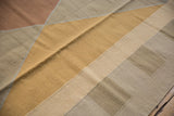 Hand woven flatweave Kilim pattern with beige, dusty gold, and copper tones.
