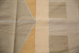 Detail of modern contemporary Kilim design with angular shapes in beige gray and dusty gold.