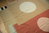 Contemporary Kilim's terra cotta, beige, and pale pink roundel with serrated motifs.