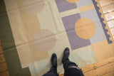 Kilim rug with abstract circles, geometric blocks, and zipper design in sand, olive, and blue-grey.