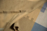 Folded Contemporary Kilim rug detail with beige, ivory, and pale blue rectangular pillars.