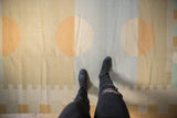 Abstract contemporary Kilim rug with beige, gold, and slate blue circles, underfoot perspective.