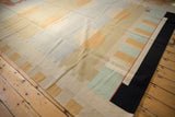 Contemporary Kilim corner with black border, pale mint, raspberry, and beige abstract blocks.